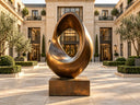 Finished abstract bronze sculpture displayed in a luxury courtyard, representing the bronze sculpture casting process for buyers and designers