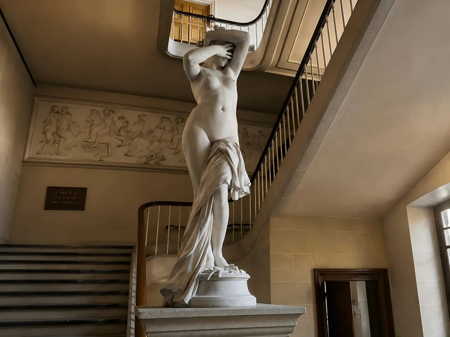 Classical stone sculpture displayed in a luxury architectural interior, showcasing timeless craftsmanship, natural stone texture, and preservation value