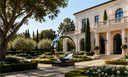 Luxury villa garden featuring a modern outdoor sculpture integrated with elegant landscape design and Mediterranean architecture