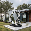 Abstract mirror-polished stainless steel loop sculpture displayed outside a modern luxury villa.