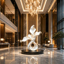 Contemporary abstract stainless steel sculpture displayed in a luxury hotel lobby with modern architectural interior design