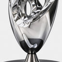 Close-up of the sculptural lower section and polished stainless steel base, highlighting the smooth transitions between intertwined metal forms.