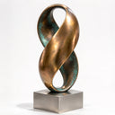 Photographed for a studio catalog, this blue-green patina bronze sculpture displays a twisted figure-eight silhouette, representing a contemporary abstract bronze artwork.