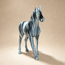 Close-up detail of abstract stainless steel horse sculpture showing glossy painted surface and artistic finish