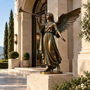 Bronze angel blowing a trumpet statue BB-020 positioned beside an elegant landscaped garden entrance