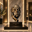 Front view of a bronze king head sculpture on a pedestal