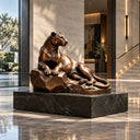 Bronze panther sculpture reclining on a rock with a black marble base, displayed in a modern indoor hall, suitable for elegant interior, hallway, and lobby art decoration.