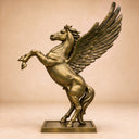 Suspended in a dynamic stance against a neutral studio backdrop, this cast bronze equine figure reveals the complete form and gleaming surface of the mythological artwork.
