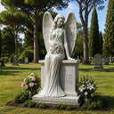 An angel monument resting on a marble pedestal, shown amidst a verdant cemetery landscape with historic tombstones and blooming flowers.