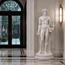 Classical white marble male statue standing in a grand indoor foyer with marble floors and large windows, suitable for luxury interior hall and entryway decoration.
