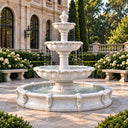 Classical tiered water fountain in an outdoor garden courtyard with stone paving and arched architecture, adding an elegant and refreshing touch to villa landscaping and patio design.