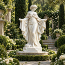 Hand-carved white marble goddess garden statue MM-041 with open arms and flowing classical drapery in a luxury estate garden