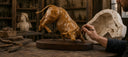 Sculptor refining a detailed clay bull model for a custom bronze sculpture