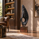 Occupying a space in executive offices, this contemporary marble floor sculpture is hand-carved with a symbolic flame silhouette to denote ambition.