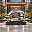 Reflecting its surroundings with a smooth curve, this contemporary steel wave sculpture is unveiled in a poolside courtyard, complementing high-end hospitality spaces.