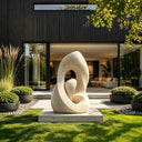 Contemporary stone abstract sculpture with organic curved design and natural texture for outdoor landscape spaces