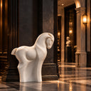 Distinguished by its minimalist silhouette and hand-carved details, this white marble horse sculpture brings contemporary equestrian art to luxury hotel corridors.