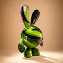 Embodying contemporary rabbit artwork, this custom fiberglass character sculpture is highlighted against a warm studio backdrop for art collection catalogs.