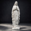 A custom marble religious statue, posed in prayer as a Virgin Mary rosary statue, is pictured against a dark studio backdrop for product catalogs.