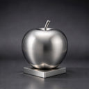 Under the studio lights, this custom stainless steel apple artwork shows a smooth brushed metal finish, documented for outdoor fruit sculpture catalogs