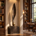 Opening from a slender, flame-like silhouette into an elongated vertical plane, this Eternal Ascent bronze sculpture is positioned for an executive library interior.

