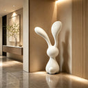 Contemporary fiberglass rabbit sculpture displayed in a luxury interior with modern architecture and elegant residential design