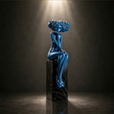 Close-up view of glossy blue fiberglass woman sculpture showing smooth handcrafted surface and polished finish