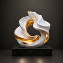 Close-up of flowing curved stainless steel sculpture showing polished reflective surface and refined metal craftsmanship