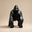 Close-up detail of geometric stainless steel gorilla sculpture showing faceted surfaces and glossy black finish