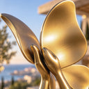 Focusing on the structural base, this golden bronze woman statue examines the smooth leg contours meeting a solid square pedestal, providing a close-up reference for design catalogs.