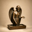 Close-up detail of handcrafted bronze angel sculpture showing refined surface texture, patina finish, and traditional metal craftsmanship