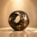 Hollow bronze sphere sculpture BB-013 with a large central opening and organic circular perforations