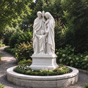 Outdoor Holy Family marble sculpture depicting Saint Joseph, the Virgin Mary, and young Jesus in a circular landscaped garden.