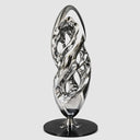 Full view of an abstract stainless steel sculpture featuring layered intertwined curves and a polished silver mirror finish.