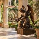 Bronze kneeling angel sculpture holding a wreath in an outdoor courtyard with arches and greenery, suitable for garden, patio, and memorial landscape decoration.