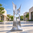 Constructed from mirror-polished stainless steel, this large abstract heart garden sculpture stands as a beacon of connection for outdoor landscape projects.