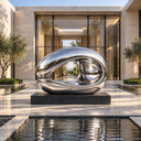 Assuming an organic wave silhouette, this large mirror-polished stainless steel sculpture is mounted on a black base, elevating luxury entrances and contemporary landscapes.