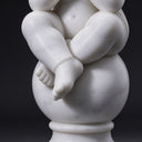 Macro detail of a marble cherub's bare feet resting atop a polished marble sphere, highlighting the sculpted toes.