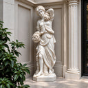 Holding a gathered bouquet, this marble harvest goddess statue leans slightly against a classical column, bringing fine white marble craftsmanship to a luxury estate foyer.