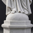 Carved Sacred Heart emblem on the chest of a natural white marble Jesus statue.