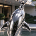 Focusing on the hydrodynamic profiles, this mirror polished dolphin sculpture explores the sleek reflective curvature of the marine animal's head and body.