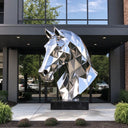 Mirror-polished geometric stainless steel horse head sculpture displayed at a modern architectural building entrance