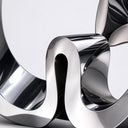 Detail of the mirror-polished ribbon curves and reflective surface of stainless steel sculpture SS-047.