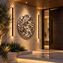 Embodying a dynamic rippled texture, this mirror polished stainless steel circular wall sculpture serves as abstract wall art for a luxury villa entrance.