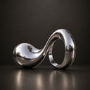 Close-up detail of mirror polished stainless steel wave sculpture showing reflective surface, smooth curves, and refined craftsmanship