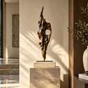 Modern abstract bronze sculpture with an organic cutout form, standing on a stone pedestal in a sunlit luxury interior corner with wooden cabinetry and greenery, ideal for high-end home art decoration.

