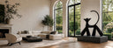 Glossy black fiberglass cat sculpture displayed in a modern luxury home interior