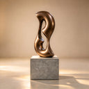 Imaged on a warm studio backdrop, this modern bronze interior sculpture emphasizes the polished finish and patinated depth of the organic abstract form for design catalogs.