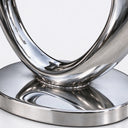 Detailed view of the smooth curved junction and polished round metal base of abstract stainless steel sculpture SS-048.