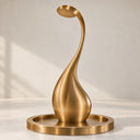 Contemporary gold stainless steel sculptural fountain featuring an elegant curved design and circular water outlet